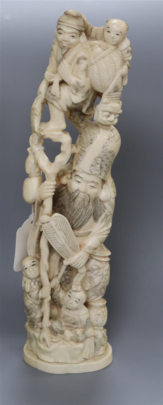 A large Japanese walrus ivory okimono of Fukurokuju and other figures